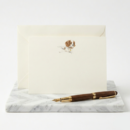 Correspondence card with dog illustration and fountain pen on marble surface