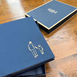 Noble Macmillan packaging with a close up of the gold foil engraving illustration