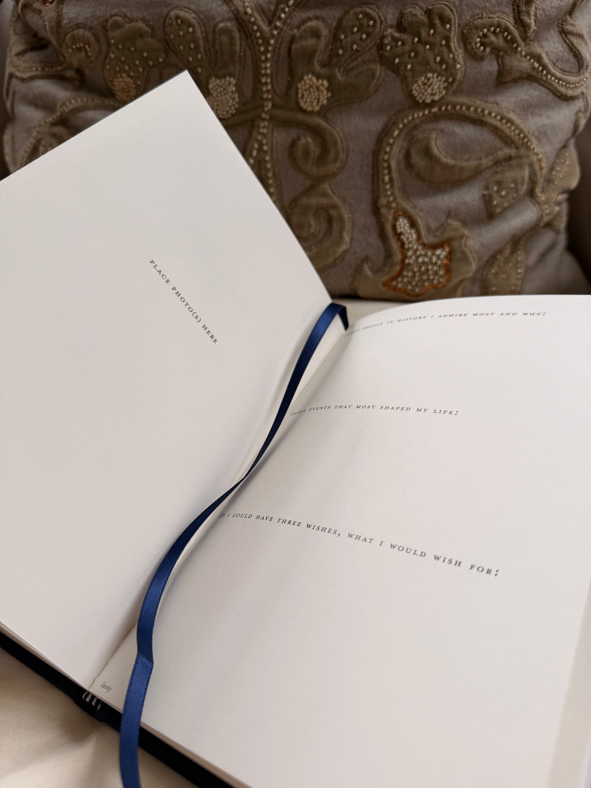 Open book with a blue ribbon bookmark showing examples of the questions within the book